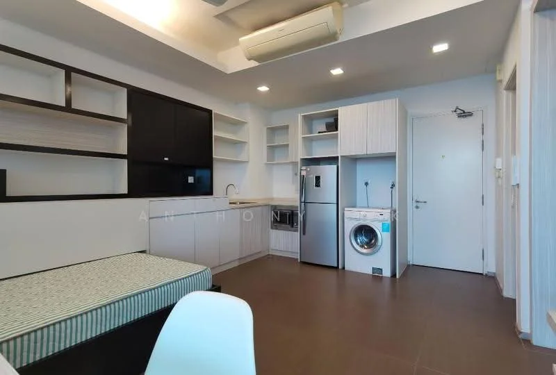 Room features: light wood cabinetry, white countertop, black wall-mounted TV, stainless-steel fridge, front-load washing machine, open shelving, single bed with mattress, air conditioning unit, recessed ceiling lights, laminate flooring, white painted walls, door to hallway; style: modern.