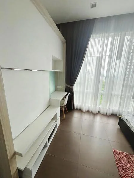 Room features: white built-in cabinetry, desk with chair, floor-to-ceiling windows, sheer curtains, grey wall, brown tiled flooring, decorative area rug, view of greenery; style: modern; view: garden.