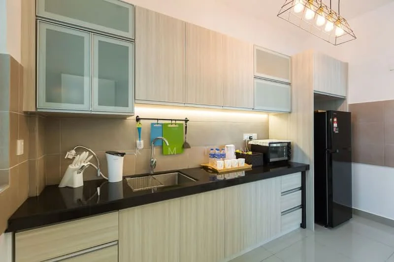 Kitchen features: black granite countertop, light wood cabinetry, stainless-steel sink, chrome pull-down faucet, built-in microwave, stainless-steel fridge, glass-front upper cabinets, tile backsplash, recessed LED downlights, kitchen island with seating, kitchen utensils on display, water bottles on countertop; style: modern.