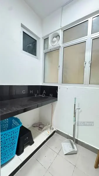 Laundry features: black countertop, white walls, grey tiled flooring, window with glass panes, blue plastic laundry basket, exhaust fan, shelf underneath countertop, cleaning tools, light fixture.