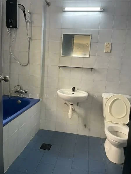 Bathroom features: bathtub with blue interior, shower head with wall-mounted holder, white pedestal sink, chrome faucet, one-piece toilet, mirror above sink, light fixture above mirror, white tiled walls, blue tiled flooring.