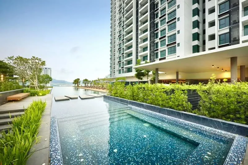 Exterior type: high-rise condominium; features: infinity pool, pool deck with loungers, landscaped garden with greenery, outdoor dining area, modern architectural design, glass curtain wall facade, surrounded by mature trees, water feature, view of the city skyline; style: modern.