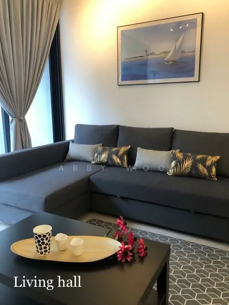Living features: L-shape sectional sofa in grey, decorative cushions with tropical pattern, coffee table with oval shape, ceramic decorative items on coffee table, framed artwork on wall, floor-to-ceiling windows with sheer curtains, area rug with geometric pattern, wall-mounted artwork, light-colored walls; style: modern.