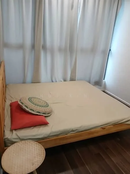 Bedroom features: queen-size bed, wooden bed frame, beige bed linen, decorative round cushion, red throw pillow, wooden stool, light grey curtains, dark wood flooring; style: minimalist.