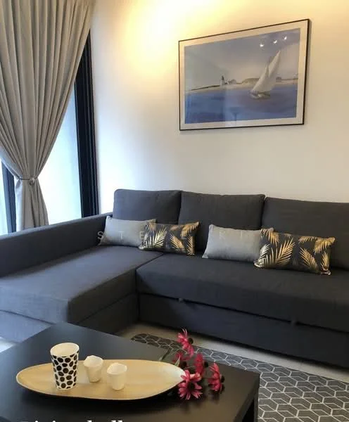 Living features: L-shape sectional sofa in grey, decorative cushions with tropical pattern, coffee table, area rug with geometric pattern, framed artwork on wall, floor-to-ceiling windows, sheer curtains, wall-mounted lighting; style: modern.