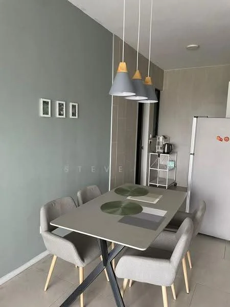 Dining features: rectangular dining table with grey surface, 4 upholstered dining chairs in light grey, 3 pendant lights with grey shades and wooden accents, light grey walls, white ceramic plates on the table, green placemats, framed artwork on the wall, floor-to-ceiling windows, tile flooring, kitchen appliances visible in the background, open layout to kitchen area; style: modern.