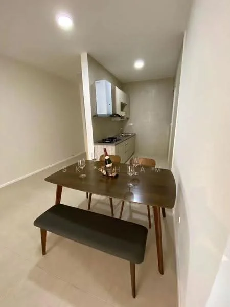 Dining features: wooden dining table, bench seating, 4 dining chairs, white walls, recessed downlights, tile flooring, kitchen area visible in background, kitchen cabinets, stainless-steel sink, gas stove, kitchen countertop; style: modern.