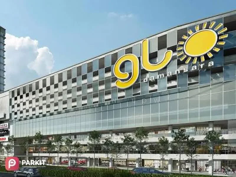 Exterior type: shopping mall; features: glass curtain wall, white painted facade, large signage with sun logo, multiple retail units visible, manicured landscaping in front, paved walkway, outdoor seating area, parking area visible, modern architectural design; style: modern.