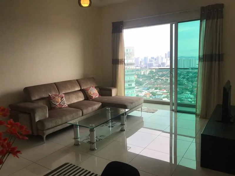 Living features: L-shape sectional sofa in beige, glass coffee table, floor-to-ceiling windows, city skyline view, cream painted walls, white tiled flooring, curtains with grey and beige tones, TV console, wall-mounted TV, decorative cushions; style: modern; view: city.