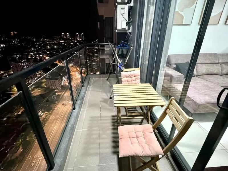 Balcony features: glass railing, tile flooring, outdoor table, two wooden chairs, city skyline view, clothes drying rack, night lighting; style: modern; view: city.