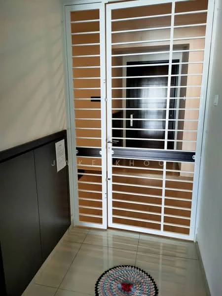 Room features: double security gate, white metal grille door, brown wooden door behind grille, cream tiled flooring, dark wood paneling on wall, decorative round rug at entrance, light beige wall, door handle on wooden door; style: modern.