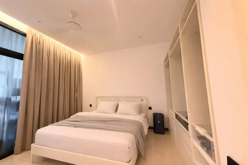Bedroom features: king-size bed with white bedding, upholstered headboard, white walls, light wood flooring, floor-to-ceiling windows, sheer curtains, built-in wardrobe with open shelving, recessed ceiling lights, ceiling fan, decorative wall paneling; style: modern; view: city.