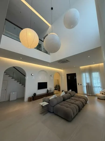 Living features: large sectional sofa in beige, coffee table, wall-mounted TV, built-in cabinetry, recessed LED downlights, 3 pendant lights, high ceiling, light-colored walls, large windows with sheer curtains, open staircase with white railing, neutral-toned flooring, decorative wall art; style: modern.
