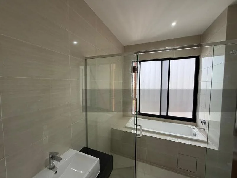 Bathroom features: bathtub, glass shower enclosure, single-bowl sink, chrome basin mixer faucet, wall-mounted mirror, tile cladding on walls, light-colored tile flooring, window with frosted glass, recessed downlights; style: modern.