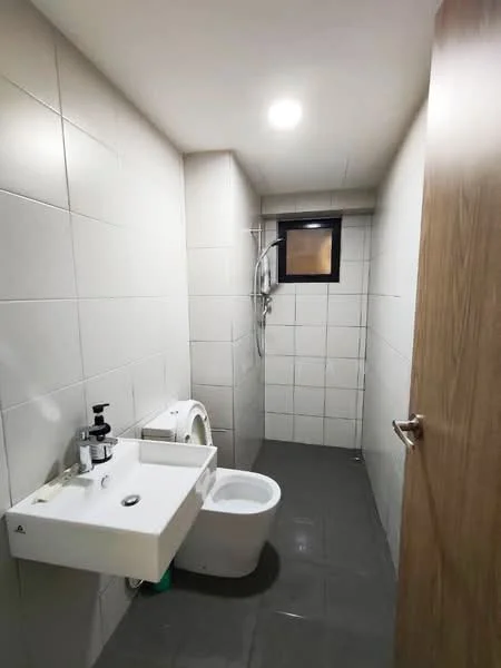 Bathroom features: white tiled walls, grey tiled flooring, single-sink vanity with wall-mounted faucet, one-piece toilet, shower area with handheld shower, window for natural light, mirror above sink, soap dispenser, toilet paper holder; style: modern.