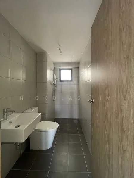 Bathroom features: grey tiled walls, dark grey floor tiles, single-sink vanity with wall-mounted faucet, one-piece toilet, walk-in shower with glass enclosure, small window for natural light, ceiling light fixture, wooden door; style: modern.