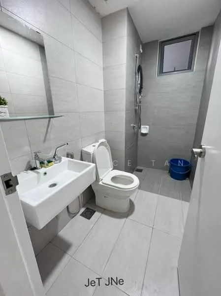 Bathroom features: grey tiled walls, light grey tiled flooring, white wall-mounted sink, chrome basin mixer faucet, one-piece toilet, shower with wall-mounted shower head, mirror above sink, glass shelf above sink, small window for natural light, blue plastic bucket; style: modern.