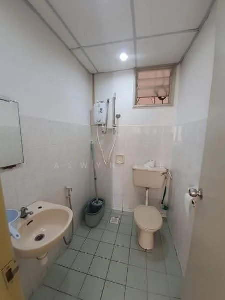 Bathroom features: white tiled walls, green ceramic tile flooring, single-sink vanity with mirror, toilet, shower with wall-mounted showerhead, water heater, window with horizontal blinds, wall-mounted soap dispenser.