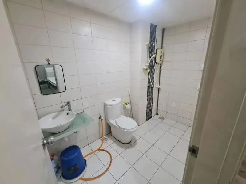 Bathroom features: white tiled walls, white tiled flooring, single-sink vanity with glass shelf, chrome basin mixer faucet, framed mirror, one-piece toilet, shower area with wall-mounted shower head, water heater unit, blue water storage tank, orange hose, light fixture on ceiling.