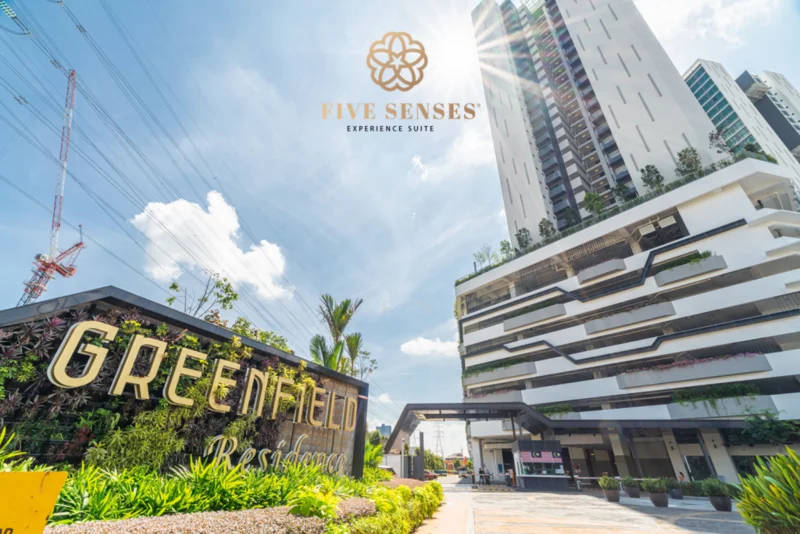 Exterior type: high-rise condominium; features: glass curtain wall, white painted facade, recessed balconies, landscaped garden with tropical plants, manicured lawn, driveway with interlocking pavers, double-volume main lobby, feature signage, surrounded by mature greenery; style: modern.