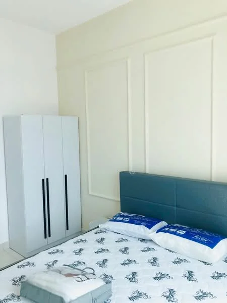 Bedroom features: queen-size bed with grey upholstered headboard, white bedding with floral pattern, 2 blue pillows, white walls with decorative paneling, light-colored tiled flooring, built-in wardrobe with grey finish and black handles, bedside rug, window with natural light; style: modern.