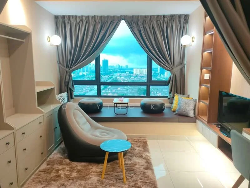 Living features: floor-to-ceiling windows, city view, beige painted walls, light brown carpet flooring, curtains in dark grey, built-in shelving unit, small round blue coffee table, grey accent pillows, sofa chair in light grey, TV console, decorative wall lighting; style: modern.