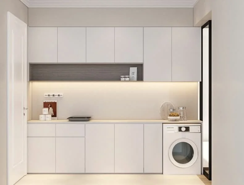 Laundry features: white cabinetry with flat-panel doors, grey countertop, built-in washing machine, recessed LED lighting, light beige wall paint, white tiled flooring, open shelving, decorative items on countertop; style: modern.