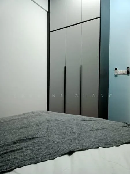 Room features: grey upholstered bedspread, built-in wardrobe with grey doors, white painted walls, blue accent wall, wall-mounted light switch, power outlet; style: modern.