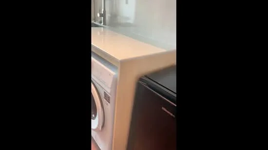 Laundry features: front-load washing machine, black fridge, white countertop, cabinets above countertop, wall-mounted faucet, tile backsplash; style: modern.