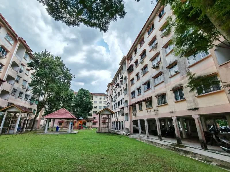 Exterior type: low-rise apartment block; features: pink painted facade, 5-storey building, surrounded by greenery, manicured lawn, covered gazebo with red tiled roof, open-air parking area, multiple windows on each floor, ground-level access, trees providing shade; style: traditional.