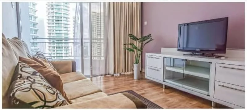 Living features: 3-seater fabric sofa in beige, decorative cushions with patterns, wooden flooring, TV console with glass shelves, wall-mounted TV, floor-to-ceiling windows, sheer curtains, indoor plant in white pot, accent wall in purple, area rug; style: modern; view: city.