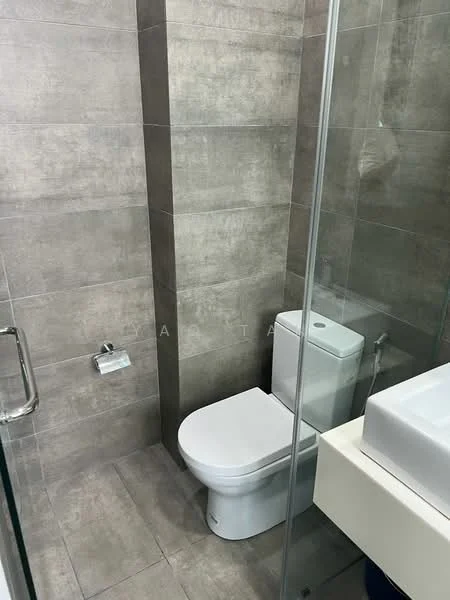 Bathroom features: grey tile flooring, grey wall tiles, glass shower enclosure, one-piece toilet, wall-mounted toilet paper holder, sink with countertop, modern faucet, mirror above sink; style: modern.