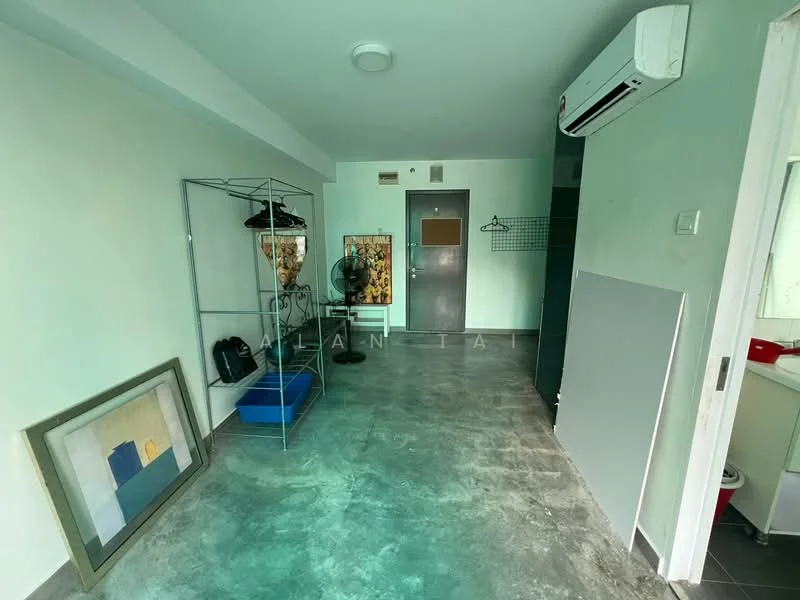 Room features: grey concrete flooring, white painted walls, ceiling-mounted air conditioning unit, clothes rack, wall-mounted coat hooks, fan, framed artwork, blue storage box, door with security lock, light fixture on ceiling; style: minimalist.
