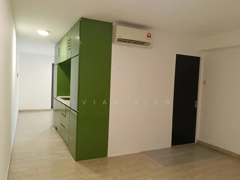 Room features: green cabinetry, white walls, laminate flooring, wall-mounted split AC, black door, open layout, kitchenette area, recessed lighting; style: modern.