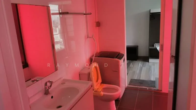 Bathroom features: white tiled walls, grey tiled flooring, single-sink vanity with mirror, chrome basin mixer faucet, toilet, shower area, washing machine, shower curtain rod.