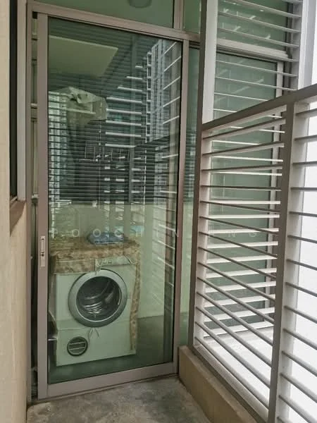 Laundry features: front-load washing machine, glass sliding door, granite countertop, metal louvered windows, concrete flooring, exposed plumbing, shelving above countertop; style: modern.