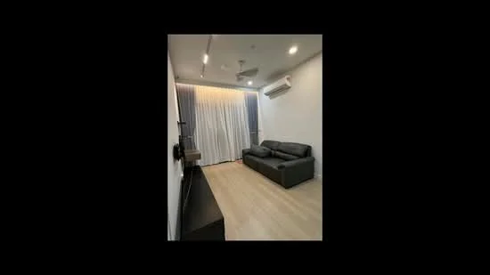 Living features: grey leather sofa, light wood flooring, white painted walls, recessed downlights, 5-blade ceiling fan, floor-to-ceiling curtains, wall-mounted TV, air conditioning unit; style: modern.