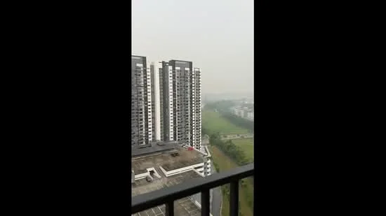 Exterior type: high-rise condominium; features: glass curtain wall, balconies on upper floors, parking deck visible, surrounded by greenery, urban landscape view, multiple storeys, modern architectural design; style: modern.