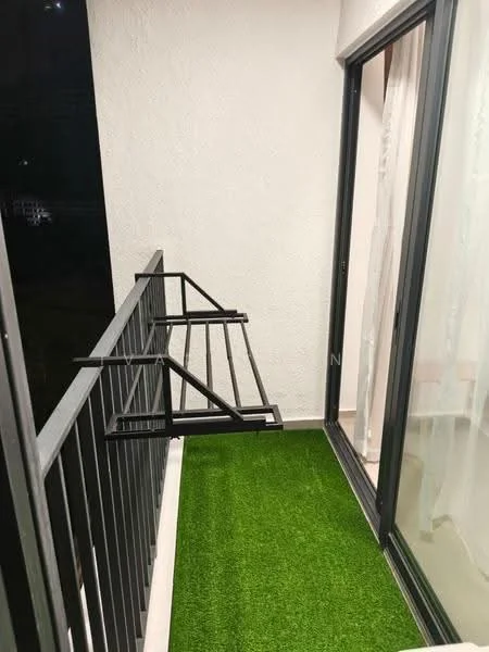 Room features: artificial grass flooring, metal railing, sliding glass door, white painted walls, balcony with space for outdoor furniture, clothes drying rack.