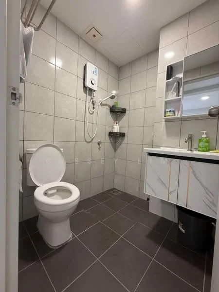 Bathroom features: grey tiled walls, grey tiled flooring, one-piece toilet, wall-mounted shower with handheld showerhead, built-in shower shelf, vanity with marble countertop, mirror above vanity, soap dispenser, toilet paper holder, waste bin; style: modern.