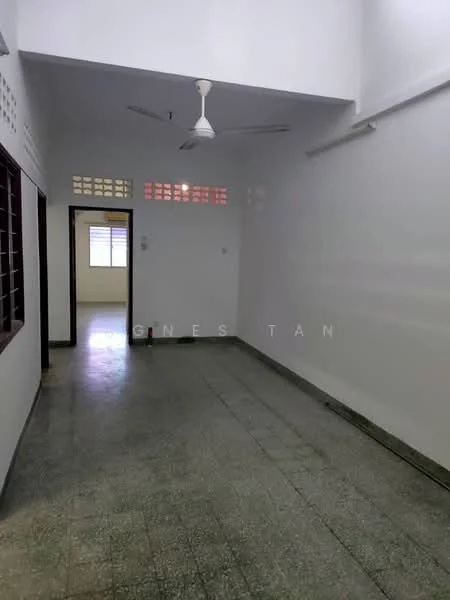 Room features: white painted walls, grey tiled flooring, ceiling fan, window with grid pattern, doorway leading to another room, natural light from window.