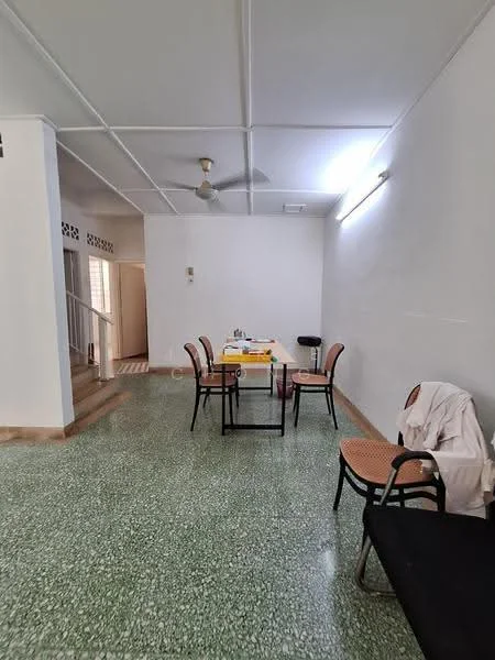 Living features: green terrazzo flooring, white painted walls, ceiling fan, dining table with chairs, black sofa, natural light from windows, light fixture on ceiling, open layout.