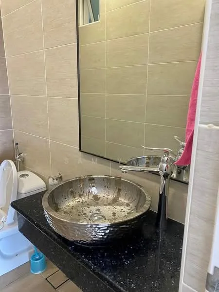 Bathroom features: round vessel sink in polished silver, chrome faucet, black granite countertop, wall-mounted mirror, light beige tiled walls, light beige tiled flooring, toilet, pink towel, wall-mounted soap dispenser; style: modern.