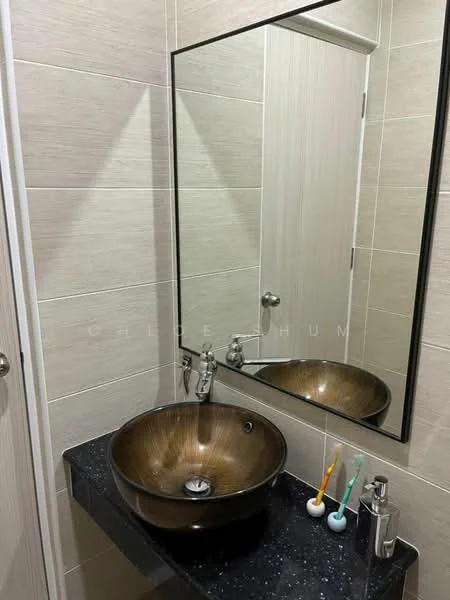 Bathroom features: brown vessel sink, chrome faucet, black countertop, mirror with frame, beige tiled walls, white door, toothbrush holder, wall-mounted soap dispenser; style: modern.