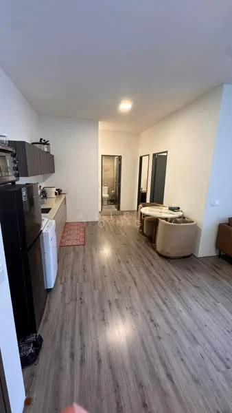 Room features: laminate flooring, white painted walls, recessed downlights, kitchen cabinetry in dark wood, black refrigerator, white washing machine, sofa chair in beige, dining table, open layout, doorways leading to other rooms; style: modern.