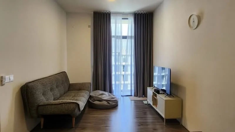 Living features: grey fabric sofa, bean bag, wall-mounted TV, TV console with storage, floor-to-ceiling windows, sheer curtains, wooden flooring, clock on wall, recessed lighting; style: modern.