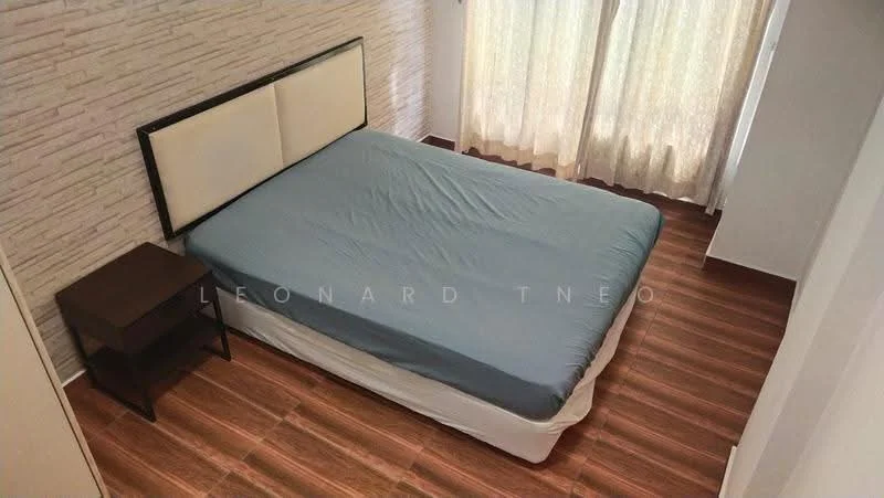 Bedroom features: queen-size bed with blue bedding, upholstered headboard, wooden bedside table, laminate flooring, light-colored wall with stone pattern, floor-to-ceiling curtains, natural light from window; style: modern.