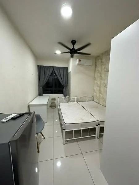 Bedroom features: white painted walls, tile flooring, 5-blade ceiling fan with light, floor-to-ceiling window with grey curtains, double bed frame without mattress, white desk, grey chair, fridge, air conditioning unit; style: modern.