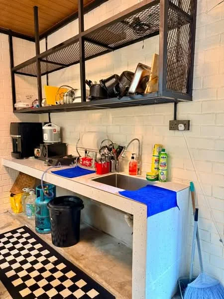 Laundry features: concrete countertop, double-bowl stainless-steel sink, chrome pull-down faucet, black and white checkered mat, open shelving with metal frame, various kitchen utensils, cleaning supplies, plastic storage bins, wall-mounted electrical outlet; style: modern.