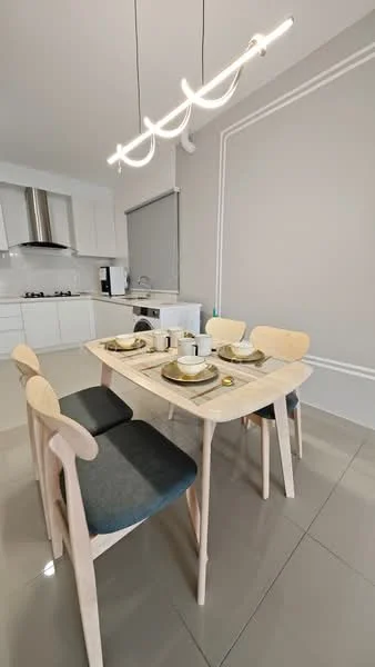 Dining features: light wood dining table, 4 dining chairs with blue cushions, white ceramic plates, silver cutlery, glass drinking glasses, modern pendant light fixture, grey painted walls, glossy tile flooring, kitchen cabinetry visible in background, stainless-steel range hood visible, window with roller blinds; style: modern.